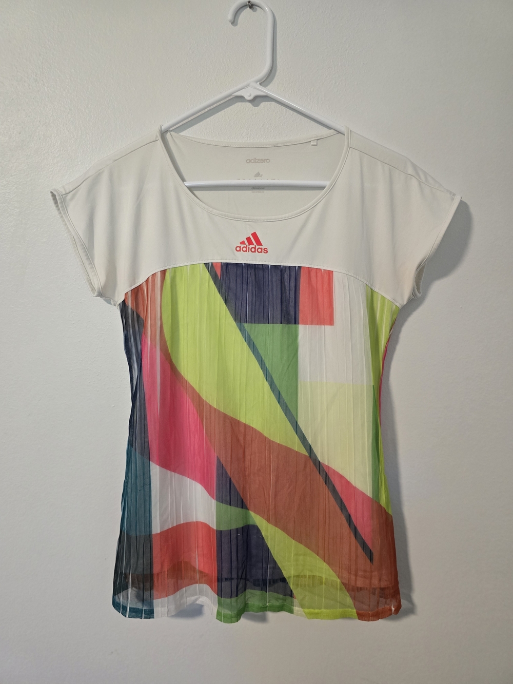 Adidas Adizero layered tennis shirt featuring a white top panel and a geometric